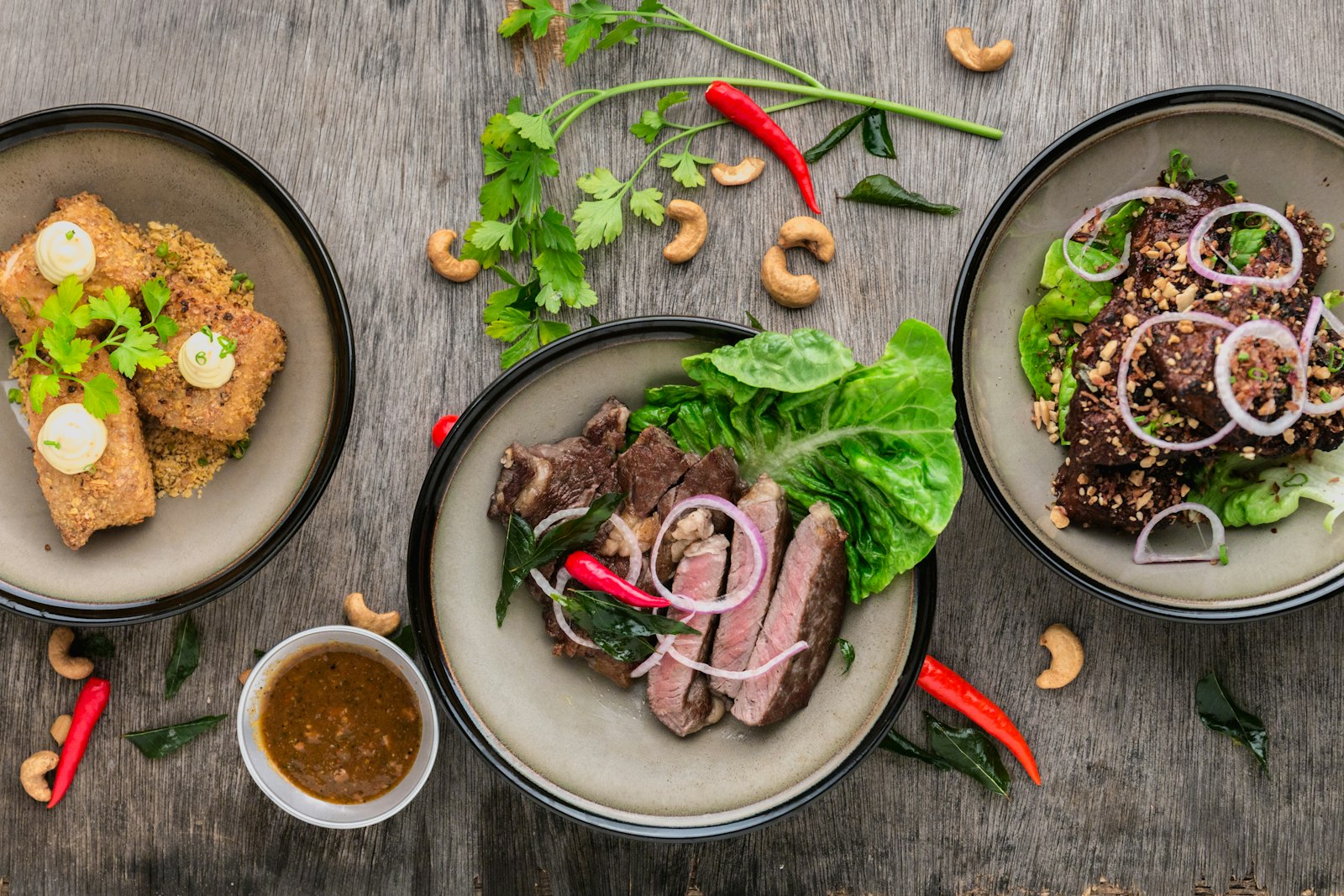 Sliced cider-braised pork shoulder in a shallow braising dish with pan juices