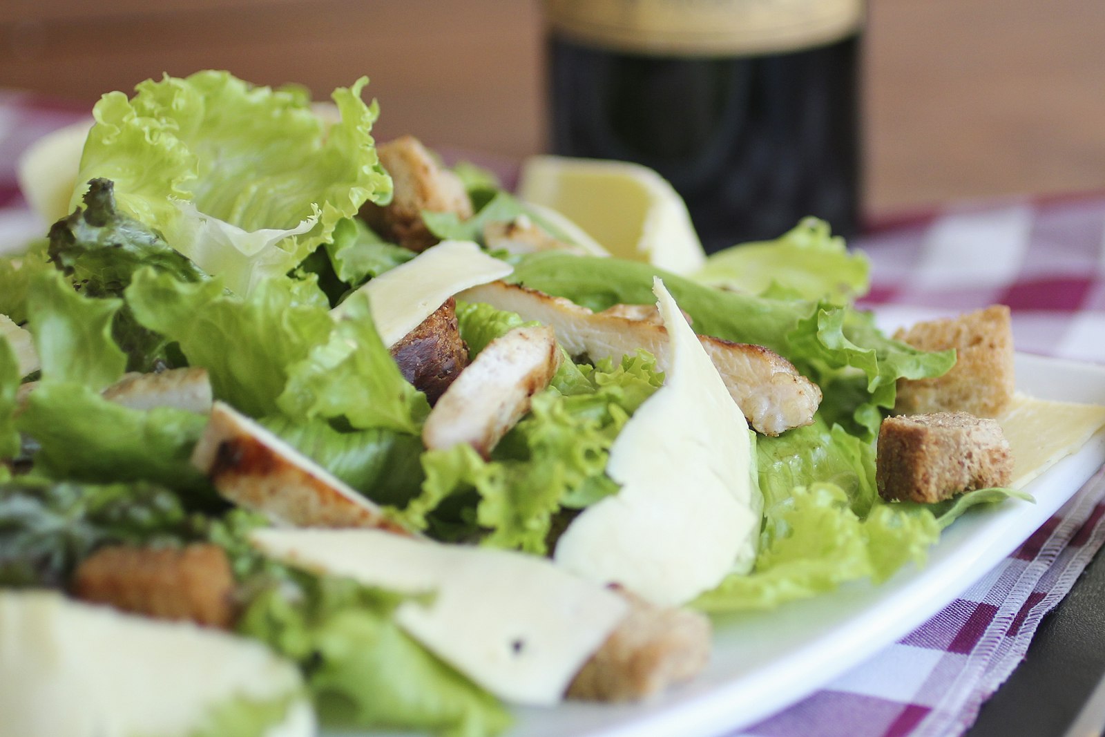 Chopped green salad tossed in a pale herb dressing in a wide bowl